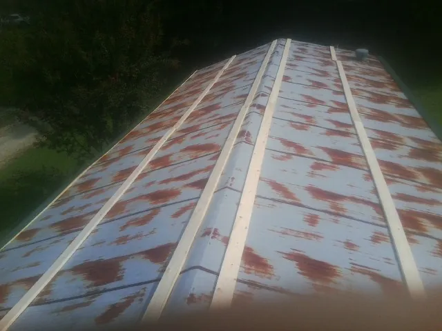 Rusted metal roof panels with new wood purlins before replacement — Storm Damage Roof Repair in Rockville by Roofing Brothers